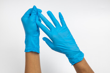 Female hand wears a protective glove for cleaning or tidying. Woman's hand latex glove gesture isolated on white. Female hand putting on latex glove isolated on white background