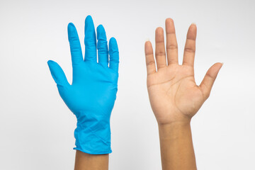 Fototapeta premium Female hand wears a protective glove for cleaning or tidying. Woman's hand latex glove gesture isolated on white. Female hand putting on latex glove isolated on white background