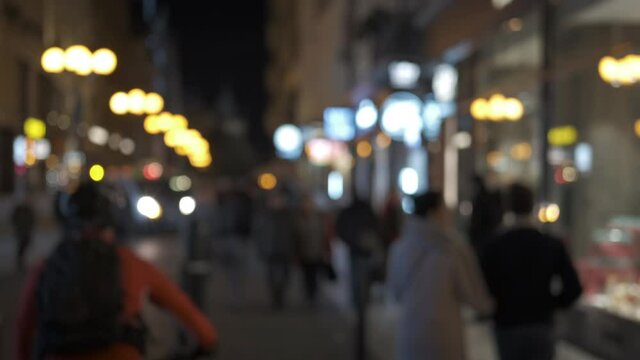 People in the night old Europe street. Vespers city pedestrian street in blur.