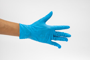 Hand of surgeon in blue medical glove showing Ok sign, isolated on a white background