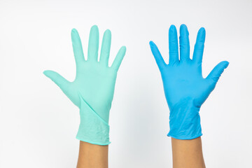 Obraz premium Woman hand wearing a Green and blue rubber medical glove on white isolated background.