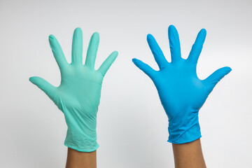Woman hand wearing a Green and blue rubber medical glove on white isolated background.