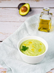 Homemade cream soup of cucumbers and avocado. Top view