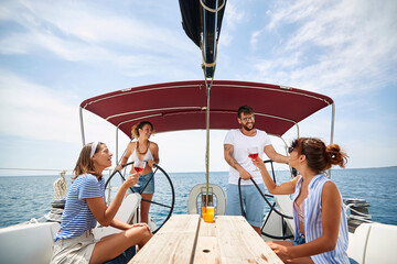 Obraz premium Friends chill with wine on a yacht