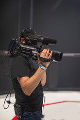 Fototapeta na wymiar cameraman on the set of the ultimate fighting show.