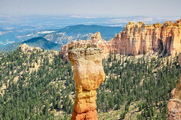 Giant vertical spire against the backdrop of a gorge and sandy cliffs in Bryce Canyon National Park. Utah, USA