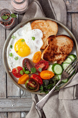 Fried eggs with vegetables and toast bread
