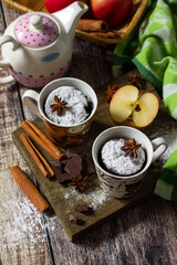Quick autumn dessert. Autumn apple pie mugcake with red apples and spices on a rustic background. Copy space.