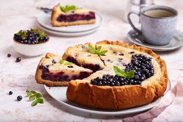 Jellied open pie tart with blueberry and cream filling. Delicious summer homemade dessert.