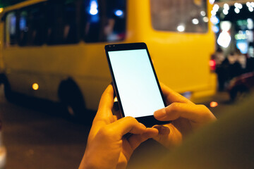 Mobile phone in female hands at night
