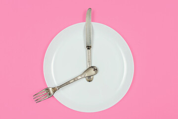 Importance of Eating Regularly. Time to breakfast, plate as a clock shows eight in the morning 