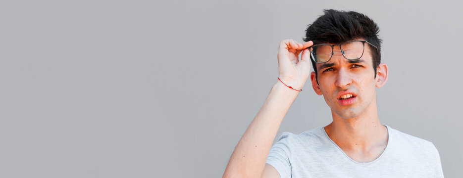 Portrait of shocked young man and glasses with open mouth.