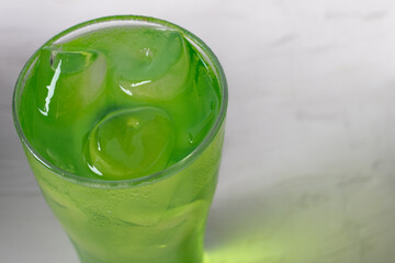 Pandan juice in ice on a green background