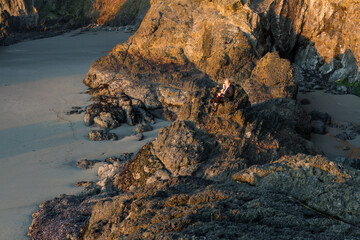 sitting on a rock with a pet