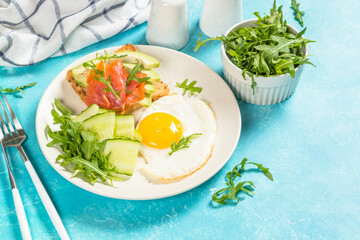 Healthy breakfast with egg, toast and salad.
