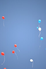 Red, blue and white balloons flying high in the sunny blue sky as festive background. Happy Birthday. Back to school  

