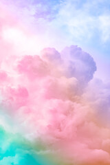 Fluffy white clouds in a bright blue sky.  Dramatic and colorful cloud background with mixed pastels.