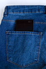 Mobile phone with blank,black screen in pocket of blue jean pants