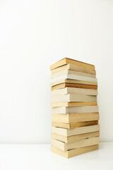 Stack of paperback books against white background with only the pages showing.