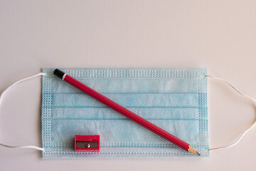 Pencil and mask, necessary objects on the way back to school