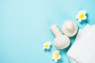 Spa herbal compressing balls on blue background.