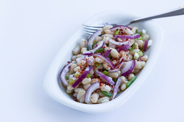 Traditional Turkish Bean,Piyaz Salad in white plate with copy space.