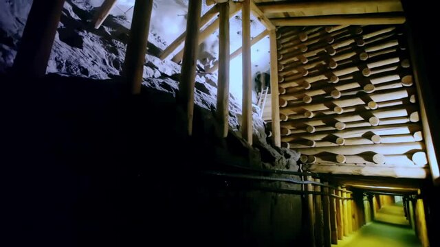 WIELICZKA, POLAND - MARCH 11, 2020: Wooden strengthening constructions over underground lake in historical salt mine in Wieliczka, Krakow