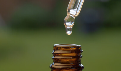 Essential oil dripping from a pipette