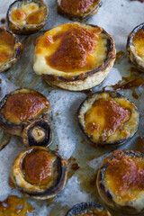 Baked with butter and cheddar mushrooms on bake paper,top view
