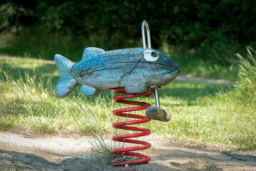 Wooden fish spring rocker in a playground