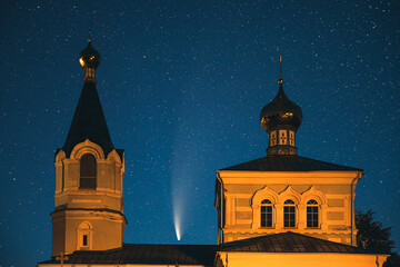 Korma Village, Dobrush District, Belarus. Comet Neowise C2020f3 In Night Starry Sky Above St. John The Korma Convent Church In Korma Village. Famous Orthodox Church And Historic Heritage
