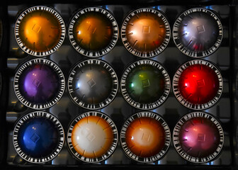 Colorful coffee pods in box for espresso and cappuccino maker, near ones purposely blurred