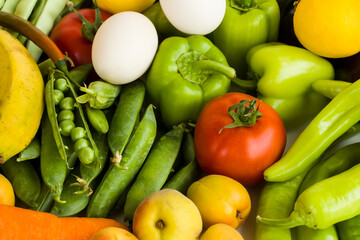 Fresh vegetables,fruits and organic white color eggs bacground,top view,flat layout.