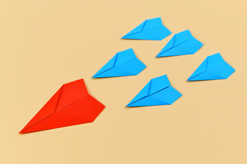 Red paper airplane leading blue airplanes. Concept for discovery and leadership