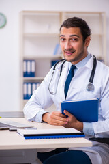Young male handsome doctor working in the clinic