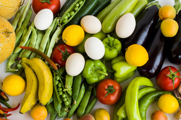 Fresh vegetables,fruits and organic white color eggs bacground,top view,flat layout.