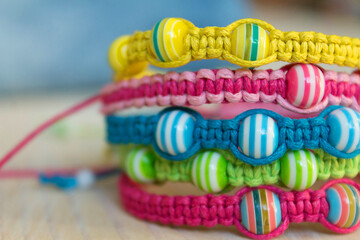bright colored bracelets with striped beads close up