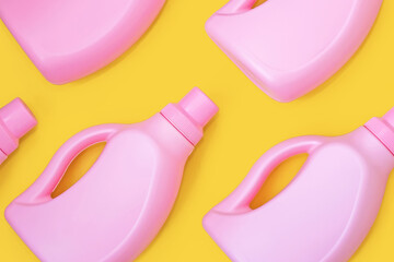 Pink bottles with chemicals for cleaning on a yellow background. Seamless pattern. Cleaning concept