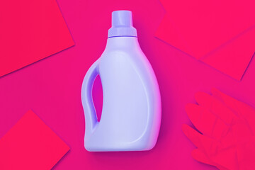 Blue bottle in the centre, red rags, red gloves on a red background. Cleaning concept
