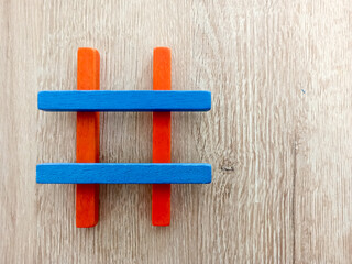 colorful wooden hashtag on wooden background