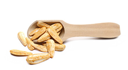 White sunflower seeds, roasted and salt with spices in wooden spoon isolated on white background