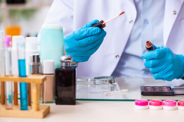 Young male chemist working in the lab