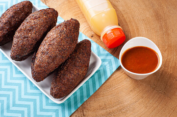 .Kibe Fried. Very typical in Brazil. Accompanied by lemon and pepper sauce. Top view