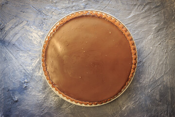 Top view of  round chocolate cake on grey background. Cake mockup concept for birthday celebrations.