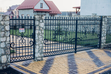 Nested pavers of various colors, around the grass is green, chic garden