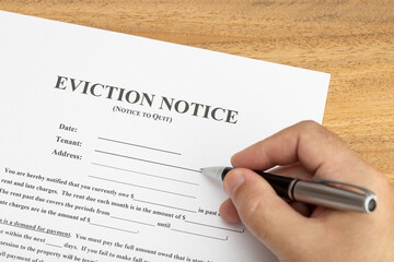 Hand ready to fill a Eviction Notice Document