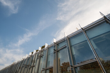 Modern glass facade office building against blue sky