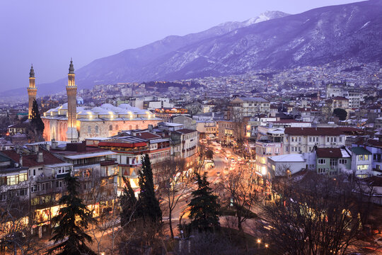 Historical Grand Mosque (Ulucami), Uludag with snow in winter and Bursa city night landscape from Bursa castle.