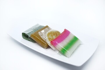 Set of Traditional snacks containing layer cakes, jenang, lemper and wingko
