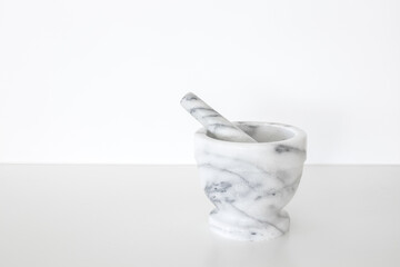 Marble mortar and pestle on a white background.